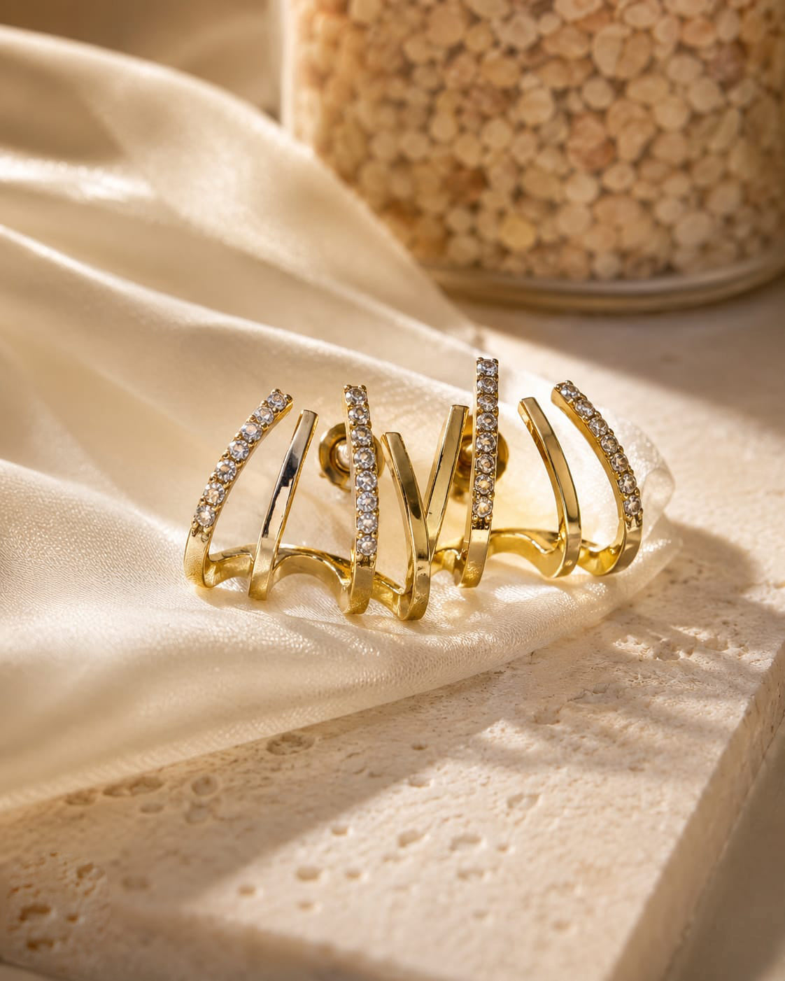 Gold plated studded claw earring