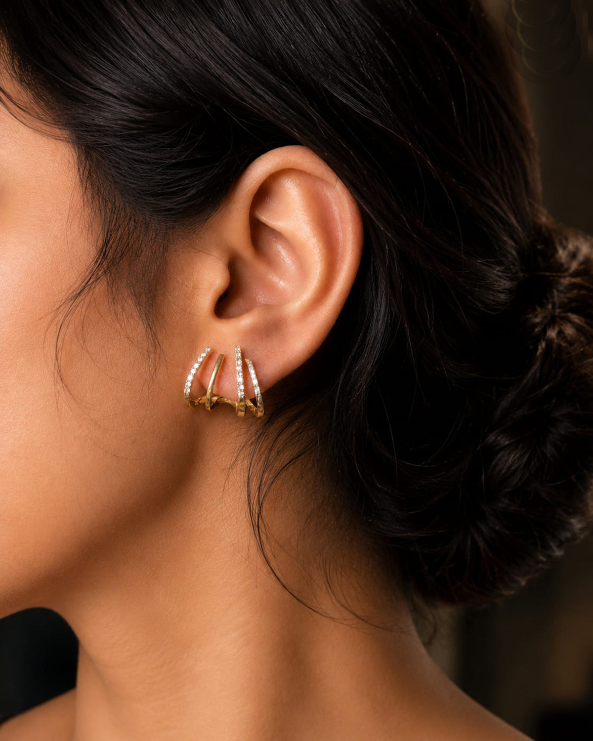 Gold plated studded claw earring